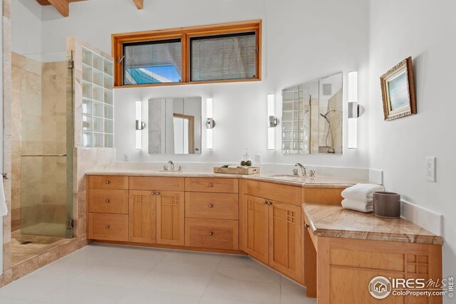 bathroom with vanity, tile patterned flooring, and a shower with door