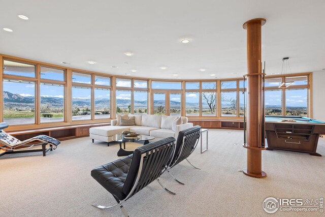 living room featuring light carpet and a mountain view