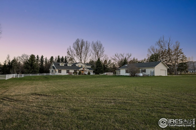 view of yard at dusk