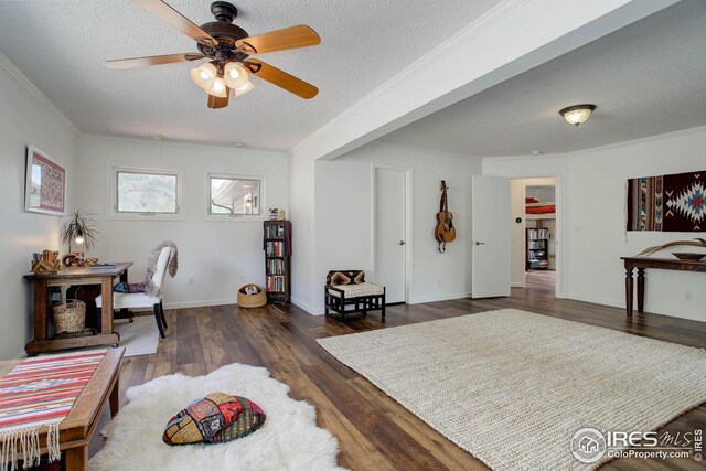 bedroom featuring ornamental molding, a textured ceiling, and wood finished floors