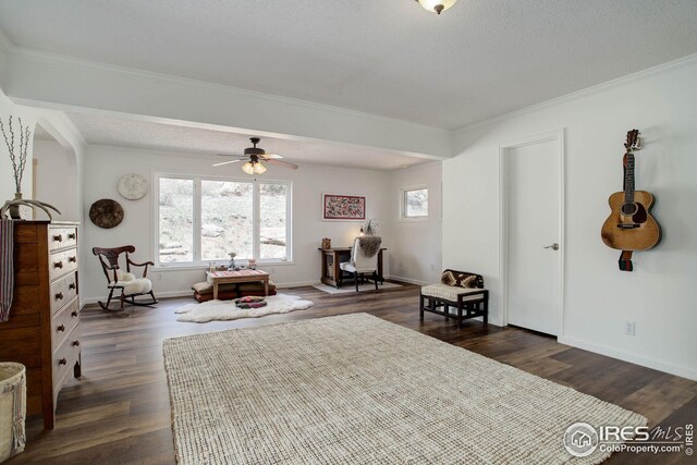 sitting room with a healthy amount of sunlight, dark wood-style floors, and crown molding