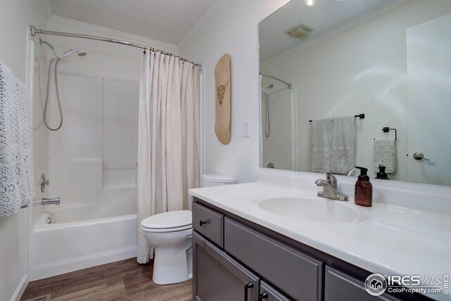 bathroom featuring shower / bathtub combination with curtain, visible vents, toilet, ornamental molding, and wood finished floors