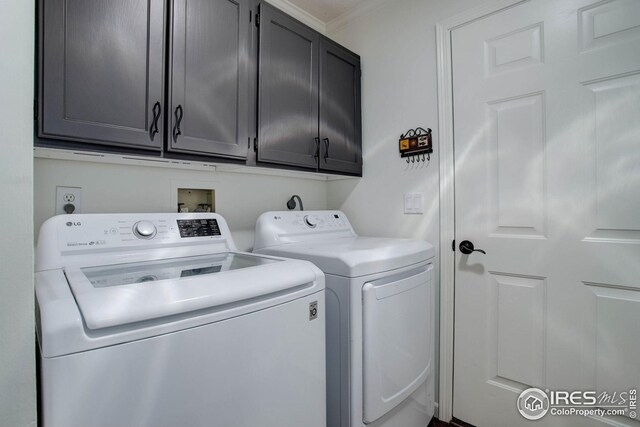 laundry room with cabinet space and washing machine and dryer