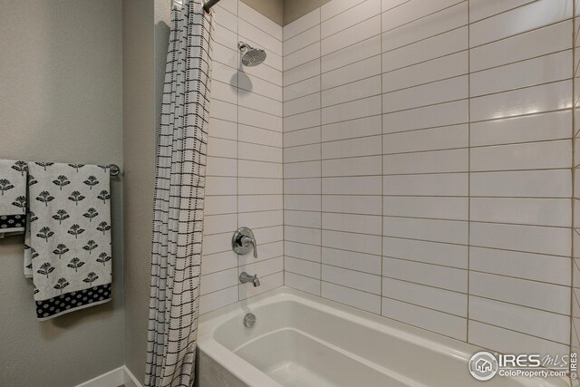 bathroom with shower / tub combo with curtain