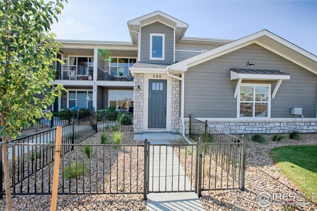 view of front of house featuring a balcony