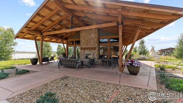 view of patio featuring outdoor lounge area and a water view