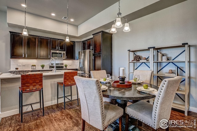 dining area with dark hardwood / wood-style flooring