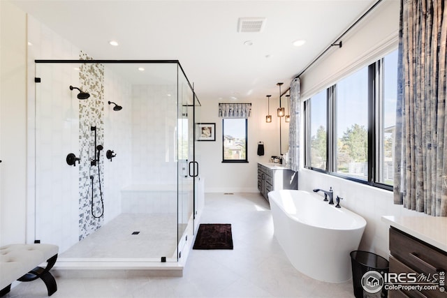 bathroom with separate shower and tub, tile patterned floors, and vanity