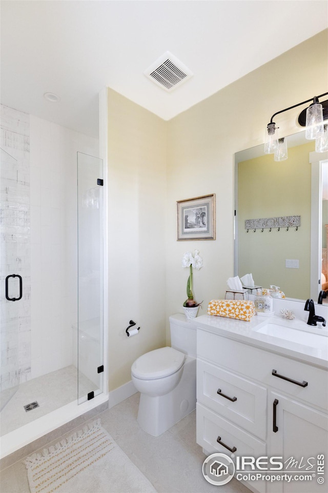 bathroom featuring toilet, tile patterned flooring, an enclosed shower, and vanity