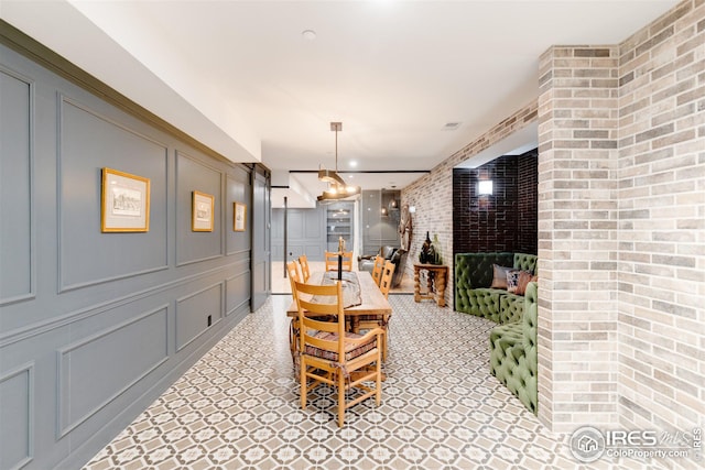 dining area featuring brick wall