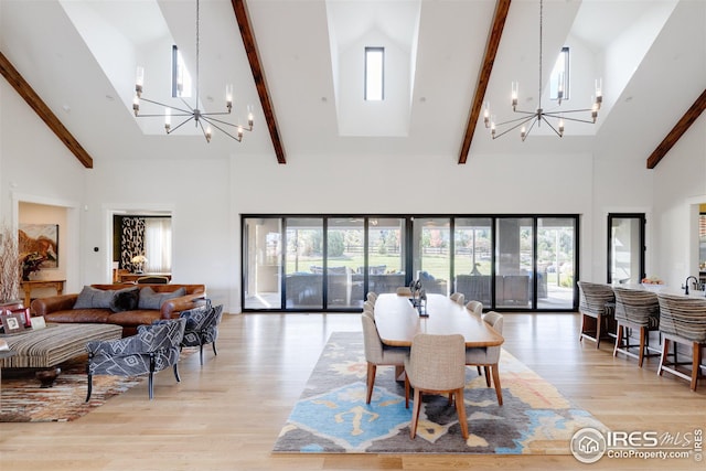dining room with an inviting chandelier, light wood-type flooring, high vaulted ceiling, and beam ceiling