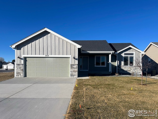 view of front of property with a front yard and a garage