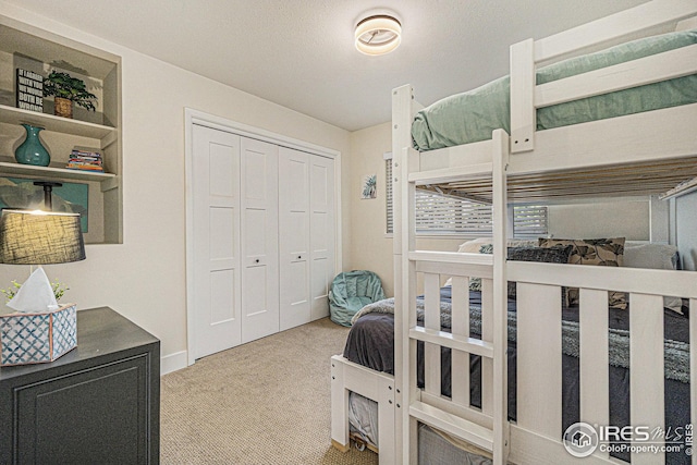 bedroom with a closet and light colored carpet