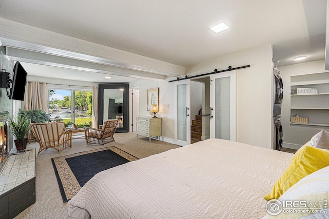 bedroom featuring carpet floors, a barn door, baseboards, and beamed ceiling