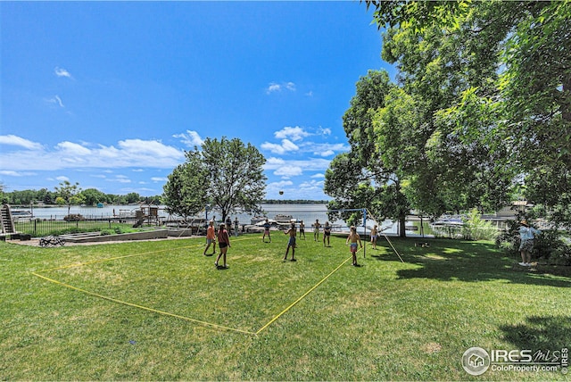 view of yard featuring a water view and fence