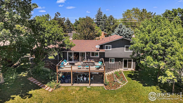 back of house featuring a patio area, a lawn, and a deck