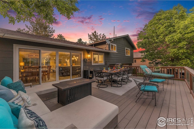 deck featuring outdoor dining area and outdoor lounge area