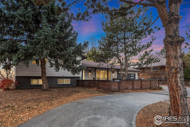 tri-level home with a fenced front yard