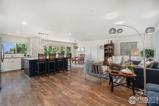 living area featuring dark wood-style floors and recessed lighting