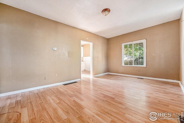 empty room with light hardwood / wood-style floors