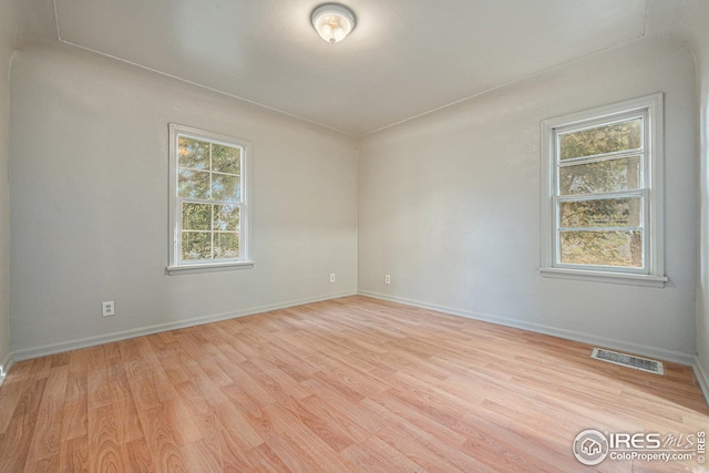 spare room with light hardwood / wood-style flooring