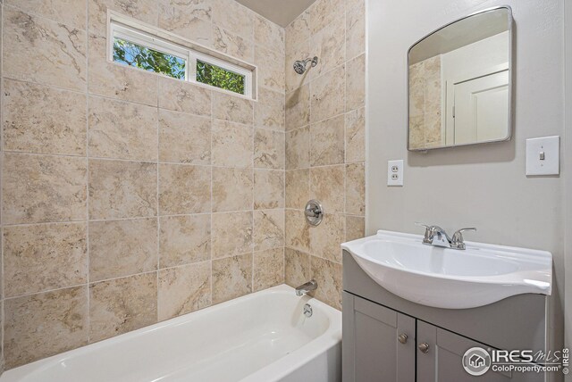 bathroom featuring vanity and tiled shower / bath combo