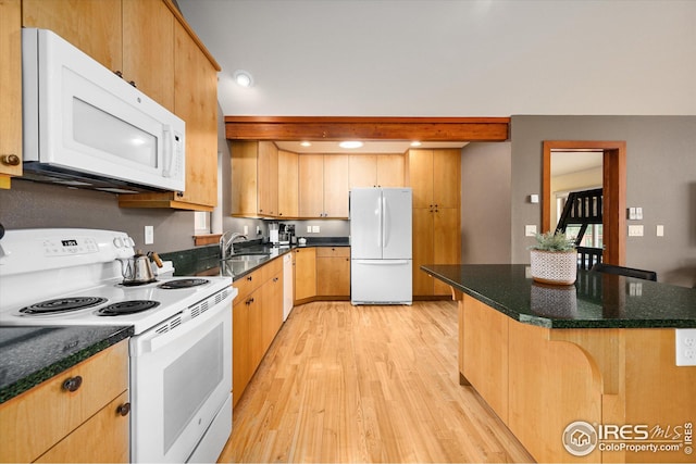 kitchen with white appliances, sink, a center island, light hardwood / wood-style flooring, and a kitchen breakfast bar