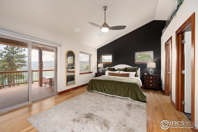 bedroom featuring light hardwood / wood-style floors, multiple windows, and lofted ceiling