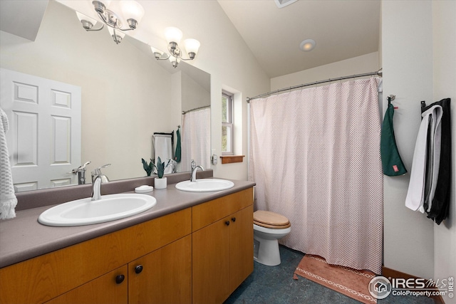 bathroom featuring toilet, an inviting chandelier, lofted ceiling, and dual bowl vanity