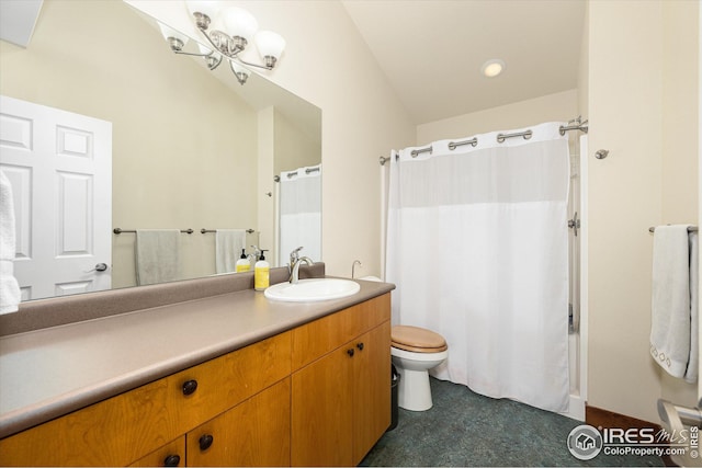 bathroom with lofted ceiling, toilet, and vanity