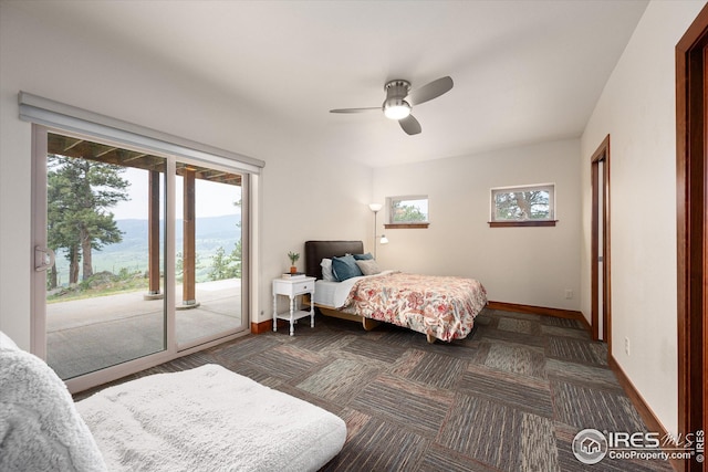 bedroom featuring access to outside, multiple windows, and ceiling fan