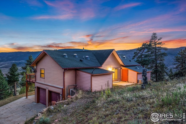 view of front of house featuring a garage and a mountain view