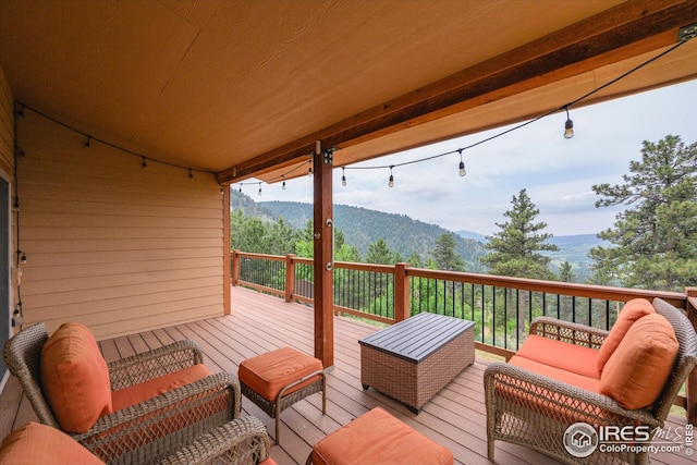 deck with a mountain view and outdoor lounge area