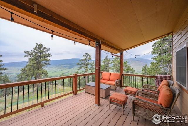 deck with a mountain view and an outdoor hangout area