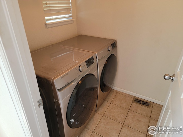 washroom with light tile patterned floors and independent washer and dryer