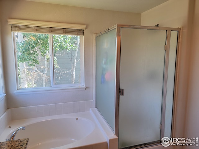 bathroom featuring independent shower and bath