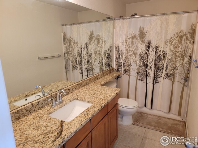 bathroom featuring tile patterned flooring, vanity, and toilet