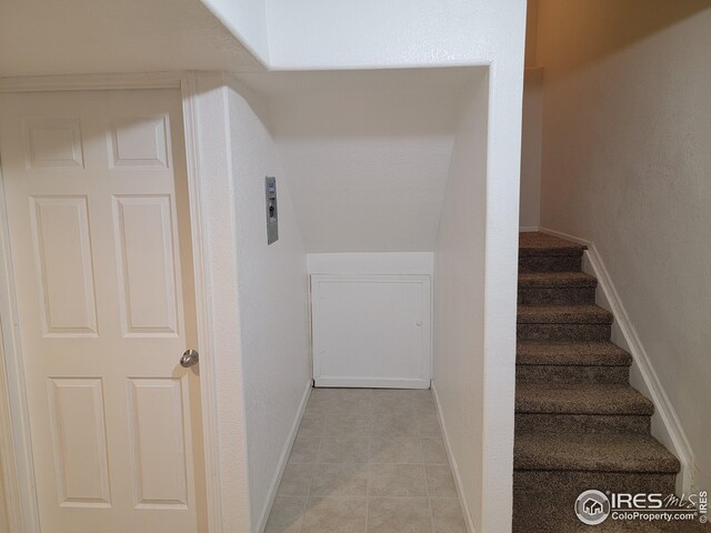 stairs featuring tile patterned flooring