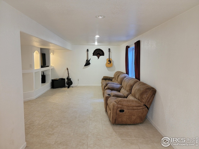 tiled living room with a textured ceiling