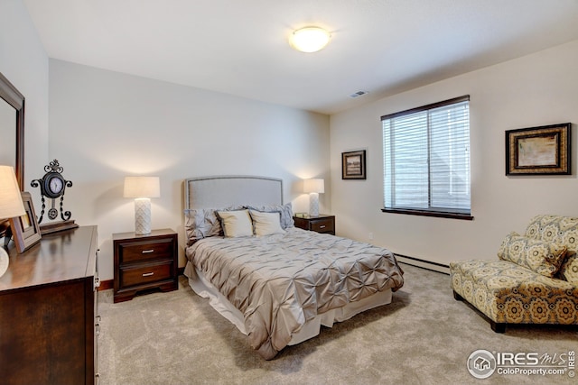 carpeted bedroom featuring a baseboard heating unit