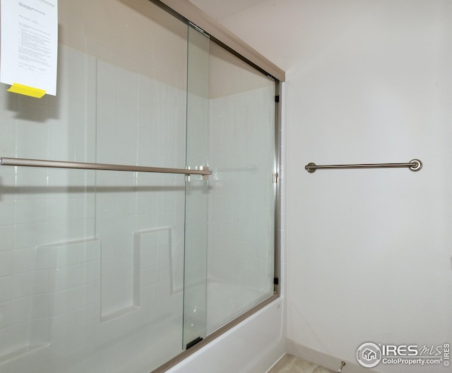 bathroom featuring shower / bath combination with glass door