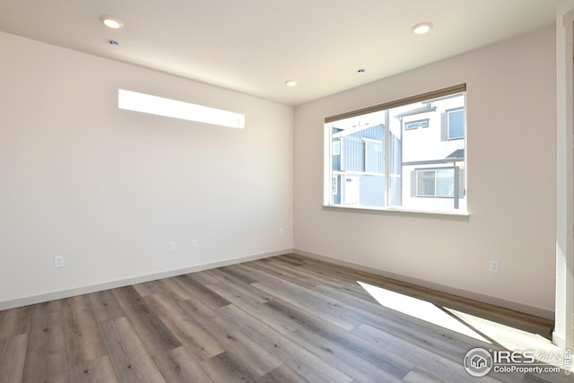 empty room with hardwood / wood-style floors