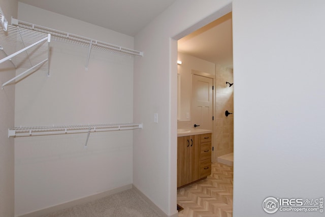 spacious closet featuring light parquet floors