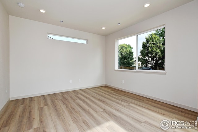 unfurnished room with light hardwood / wood-style flooring