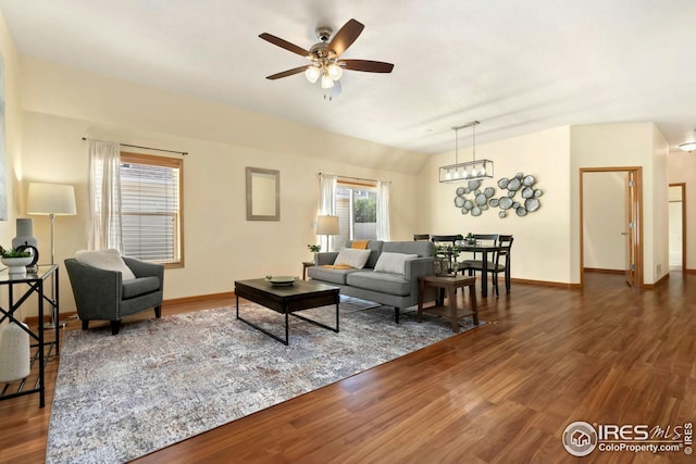 living room featuring dark hardwood / wood-style floors, lofted ceiling, and ceiling fan