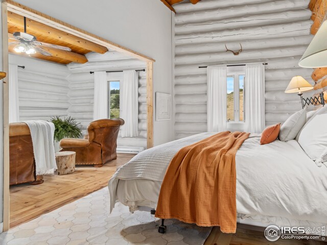 bedroom featuring rustic walls and hardwood / wood-style floors