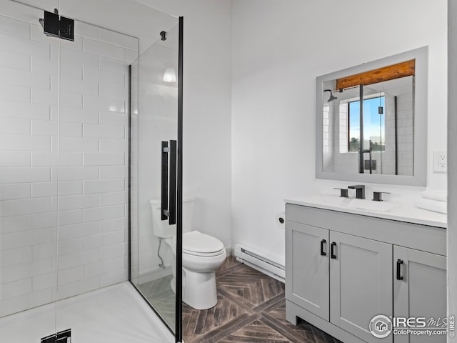 bathroom featuring parquet flooring, a shower with shower door, a baseboard heating unit, vanity, and toilet