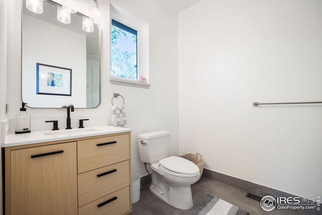 2870 18th St, Boulder, CO 80304 - bathroom featuring tile patterned flooring, toilet, and vanity