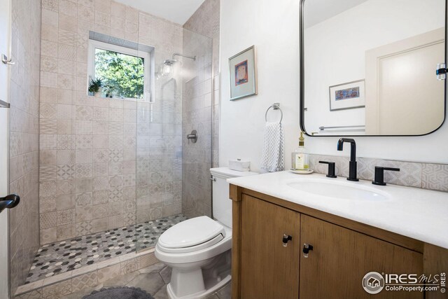 2870 18th St, Boulder, CO 80304 - bathroom with tile patterned floors, toilet, vanity, and a tile shower