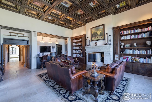 living room featuring a high ceiling and coffered ceiling